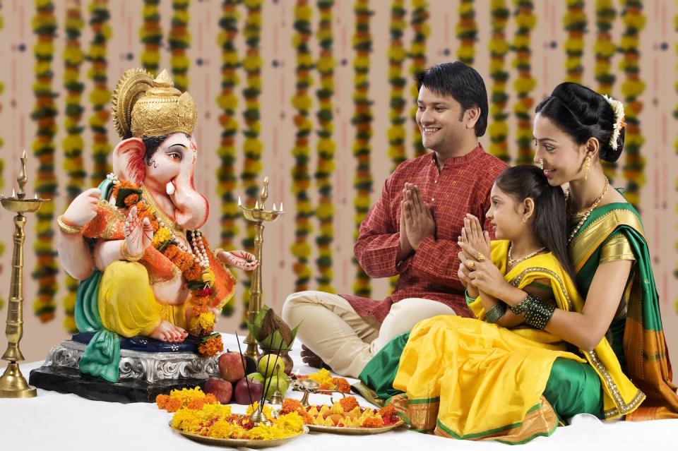 A family prays to the Hindu god Ganesha. <a href="https://www.gettyimages.com/detail/photo/family-praying-royalty-free-image/548295807?phrase=hindu+worship&adppopup=true" rel="nofollow noopener" target="_blank" data-ylk="slk:IndiaPix/IndiaPicture via Getty Images;elm:context_link;itc:0;sec:content-canvas" class="link ">IndiaPix/IndiaPicture via Getty Images</a>