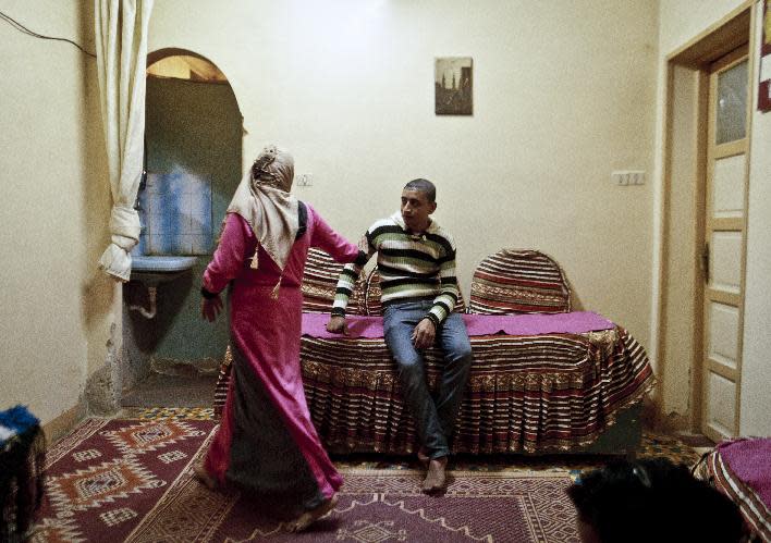 In this Monday, Dec. 10, 2012 photo, Dunia, 15, passes her fiancee at her family's apartment in Beheira, Egypt. The couple, who are cousins, married a few months later. Women activists say they won a major step forward with Egypt’s new constitution, which enshrined greater rights for women. But months after its passage, they’re worrying whether those rights will be implemented or will turn out to be merely ink on paper. Men hold an overwhelming lock on decision-making and are doing little to bring equality, activists say, and the increasingly repressive political climate is stifling chances for reforms. (AP Photo/Maya Alleruzzo) EGYPT OUT