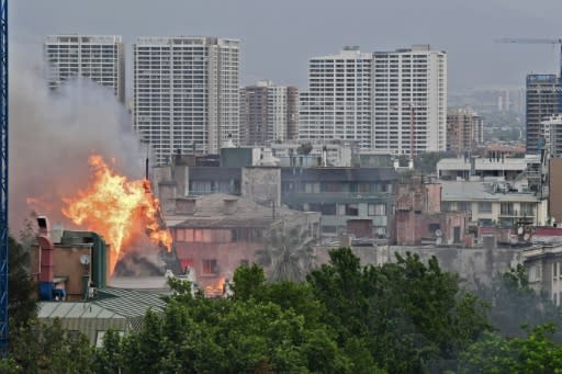 Flames rise over a private university in the latest mass protest against Chile's President Pinera