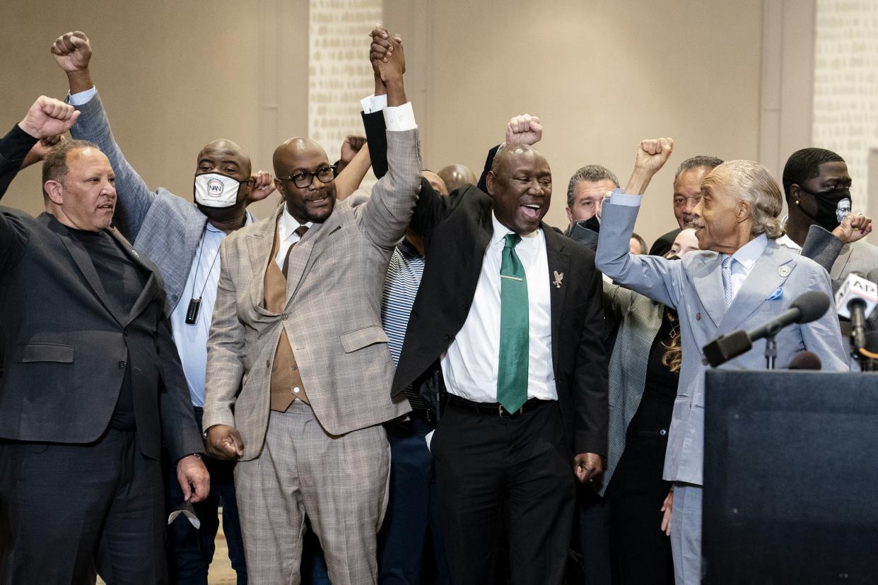 Philonise Floyd, brother of George Floyd, center left, attorney Ben Crump, center right, and the Rev. Al Sharpton, right, raise their hands during a news conference after the murder conviction against former Minneapolis police Officer Derek Chauvin in the killing of George Floyd, Tuesday, April 20, 2021, in Minneapolis.