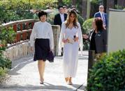<p>To tour the Morikami Museum and Japanese Gardens while hosting Japanese Prime Minister Shinzo Abe and his wife Akie Abe, Melania Trump chose a mid-calf length white dress with a matching cardigan from Calvin Klein (one of the few American designers who <span>responded with a resounding yes</span> to dressing the first lady). (Photo: Reuters) </p>