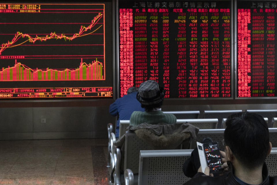 Investors monitor stock prices at a brokerage in Beijing Thursday, Jan. 16, 2020. Share prices are mixed in moderate trading in Asia after the U.S. and China signed a preliminary trade agreement that investors hope will bring better relations between the two biggest economies. (AP Photo/Ng Han Guan)