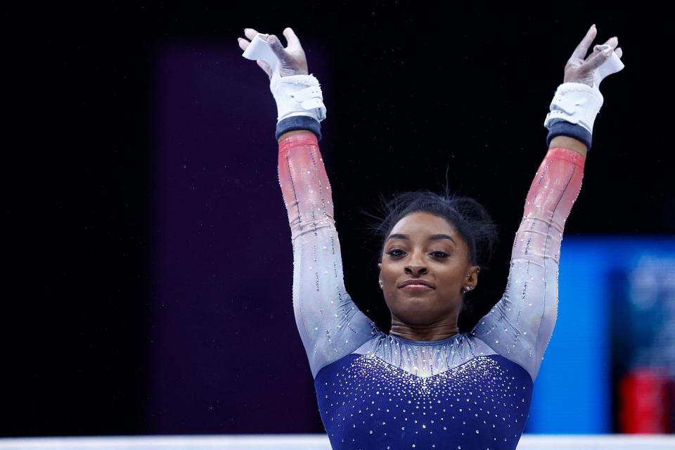 Simone Biles competes on the uneven bars in the women's team final during the World Championships, in Antwerp, northern Belgium, Oct. 4. She led the team to a record seventh consecutive team championship.