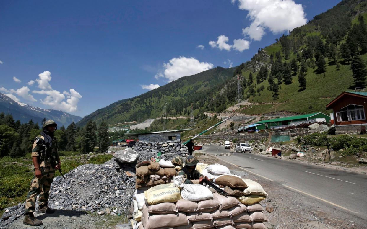 India's BSF soldiers stand guard at a checkpoint along a highway leading to Ladakah - REUTERS