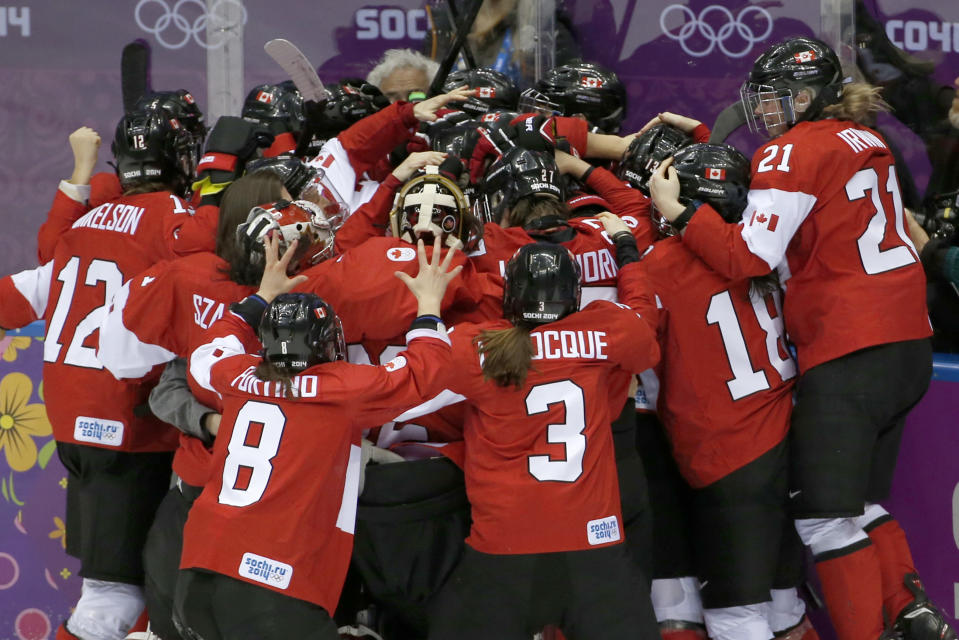Team Canada celebrates their 3-2 victory over the United States in the women's gold medal ice hockey game at the 2014 Winter Olympics, Thursday, Feb. 20, 2014, in Sochi, Russia. (AP Photo/Petr David Josek)