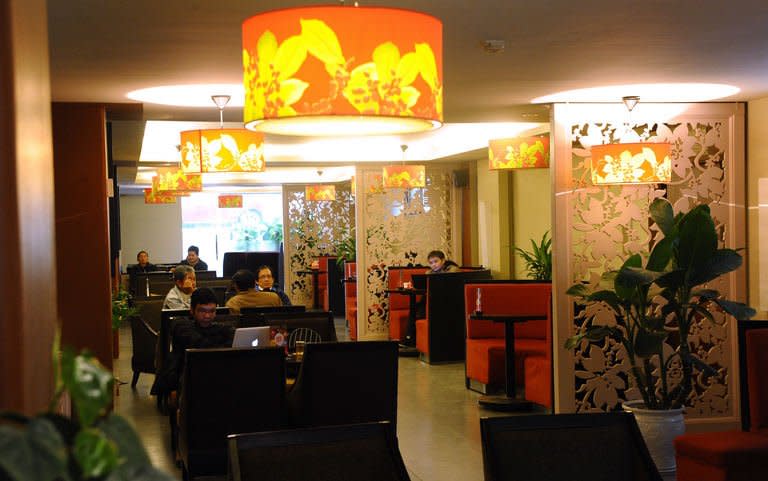 People relax as a locally run coffee shop in downtown Hanoi on January 3, 2013. Starbucks said it would open its first store in Vietnam next month, seeking a foothold in the coffee-loving country as part of efforts to expand in Asia