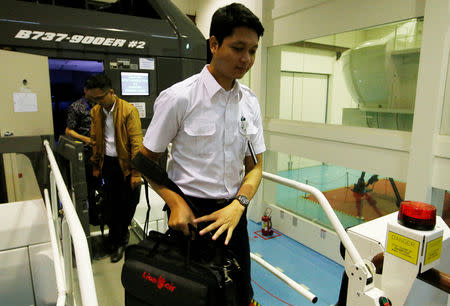 Fadil Arafat, an aviation student of Lion Air Group, leaves Boeing 737-900ER simulator after a Jet Introduction session at Angkasa Training Center near Jakarta, Indonesia, November 2, 2018. Picture taken November 2, 2018. REUTERS/Willy Kurniawan