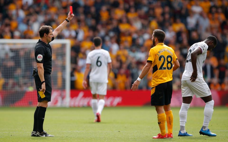 Shandon Baptiste is shown a red card by referee Darren England after receiving two yellow cards. - Reuters/Andrew Couldridge