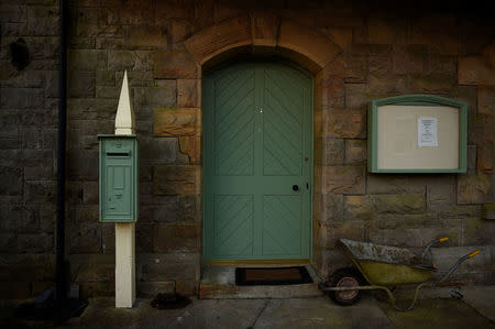 An old British postbox, painted green, stands at a disused railway station and Great Northern railway line that was for Customs and Excise on the border town of Glenfarne, Ireland, February 21, 2018. REUTERS/Clodagh Kilcoyne