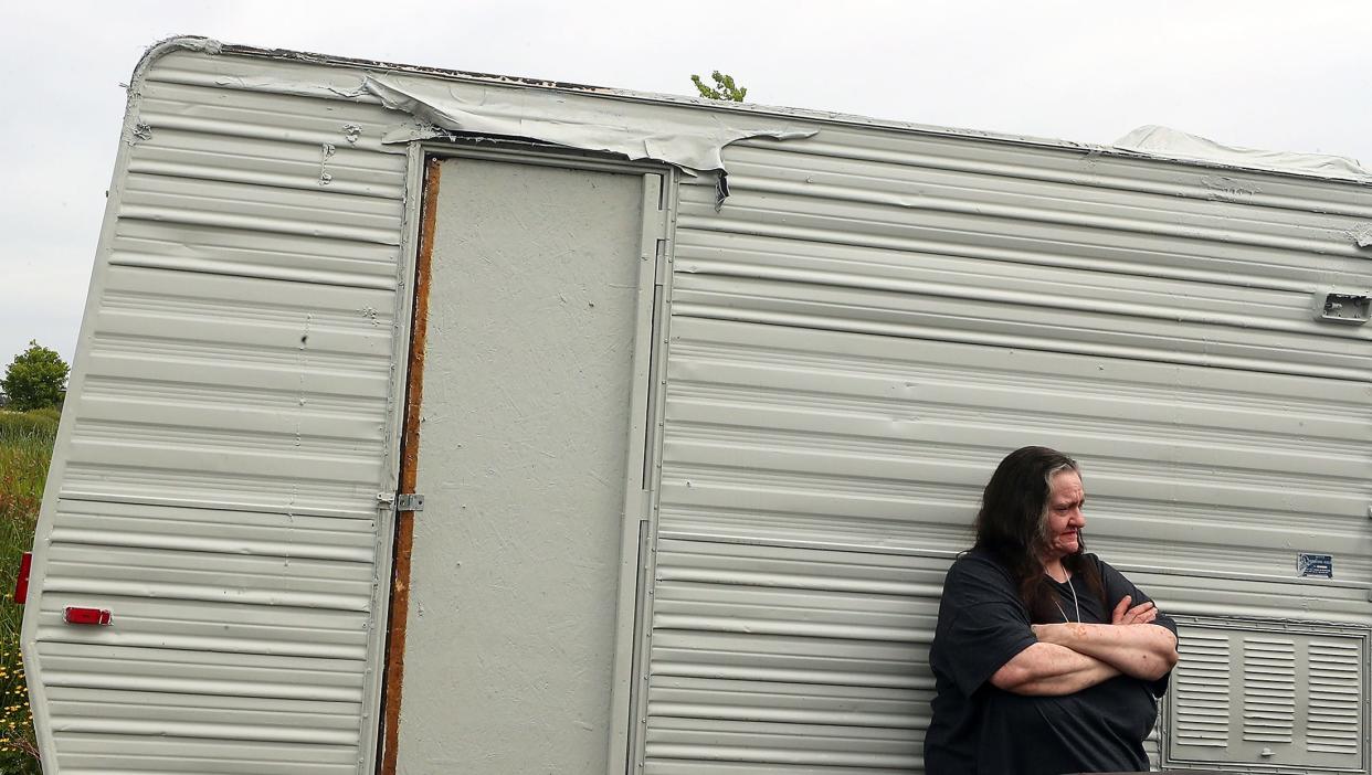 Georgina Gariepy stands outside her travel trailer parked in the county public works' property just off Poplars Avenue NW, near the Haselwood YMCA in Silverdale on Thursday.  Gariepy's RV is one in a collection belonging to people looking for permanent housing elsewhere in the county.