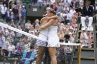 Germany's Jule Niemeier greets Germany's Tatjana Maria, left, at the net after being defeated in a women's singles quarterfinal match at the Wimbledon tennis championships in London, Tuesday July 5, 2022. (AP Photo/Kirsty Wigglesworth)
