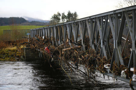 A footbridge lies littered with debris following flooding at Newton Stewart in Scotland, Britain December 31, 2015. REUTERS/Darren Staples