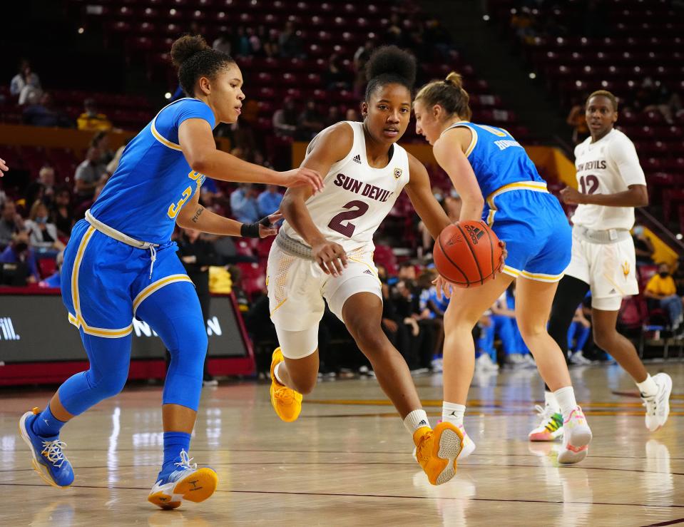 Feb 26, 2022; Tempe, AZ, USA; ASUÕs Jaddan Simmons (2) drives against UCLAÕs Jaelynn Penn (31) during a game at Desert Financial Arena. Mandatory Credit: Patrick Breen/The Republic