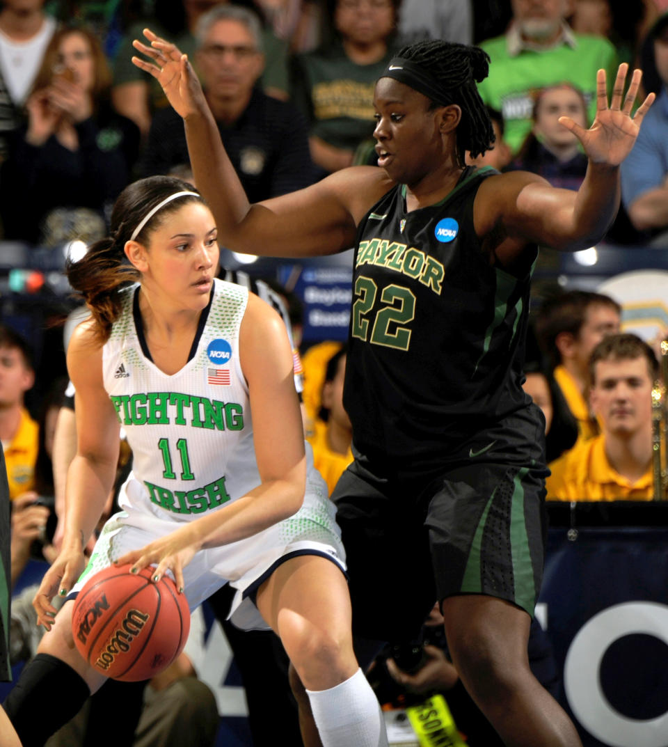 Notre Dame forward Natalie Achonwa drives the lane as Baylor center Sune Agbuke defends in the first half of their NCAA women's college basketball tournament regional final game at the Purcell Pavilion in South Bend, Ind., Monday March 31, 2014. (AP Photo/Joe Raymond)