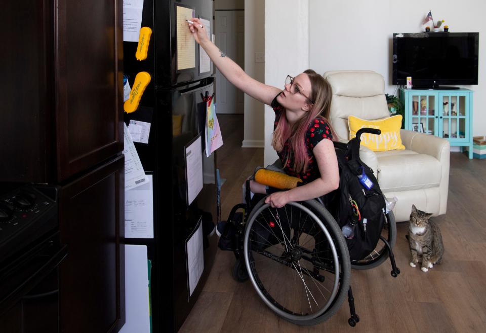 Megan Seiler crosses off a daily skills list in her kitchen Thursday, July 20, 2023. Seiler, who was born with Spina Bifida, said she used METS Mobility service for school and doctor’s appointments, but right now she’s relying on family and her caregiver to help her get where she needs to go.