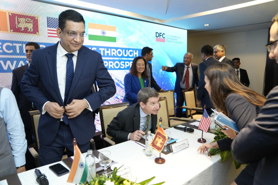 U.S. International Development Finance Corporation (DFC) Chief Executive Officer Scott Nathan, sitting, talks to an unidentified person as Sri Lanka's Foreign Minister Ali Sabry, left, prepares to leave after their meeting in Colombo, Sri Lanka, Wednesday, Nov.8, 2023. The U.S. announced a $553- million project Wednesday to build a new, deep-water shipping container terminal in the Port of Colombo as it competes with China in international development financing. (AP Photo/Eranga Jayawardena)