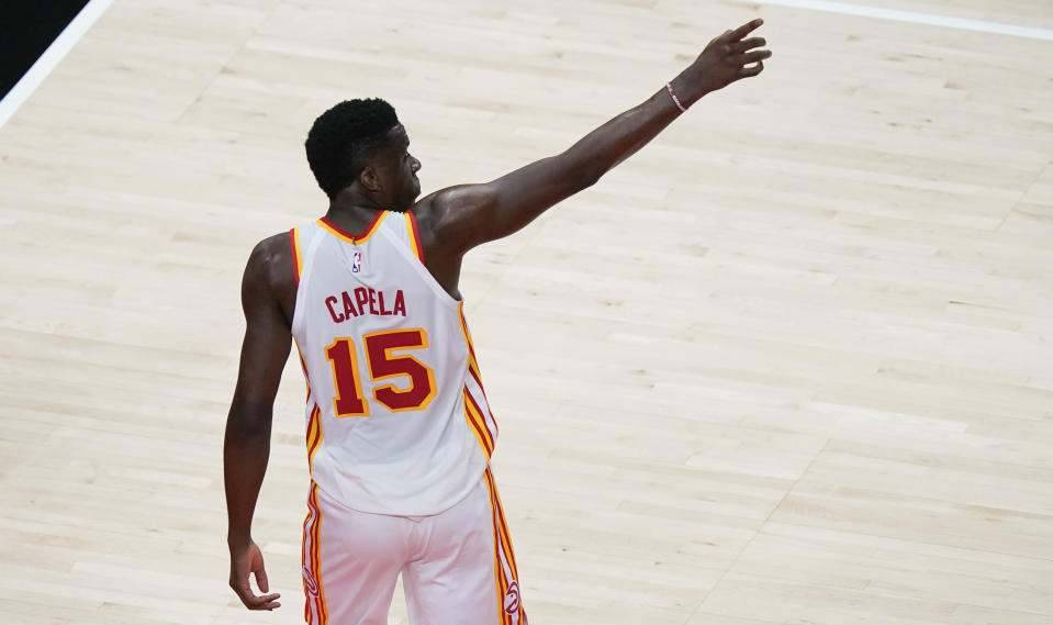 Atlanta Hawks center Clint Capela points in the crowd after scoring against the Indiana Pacers during the first half of an NBA basketball game on Sunday, April 18, 2021, in Atlanta. (AP Photo/Brynn Anderson)