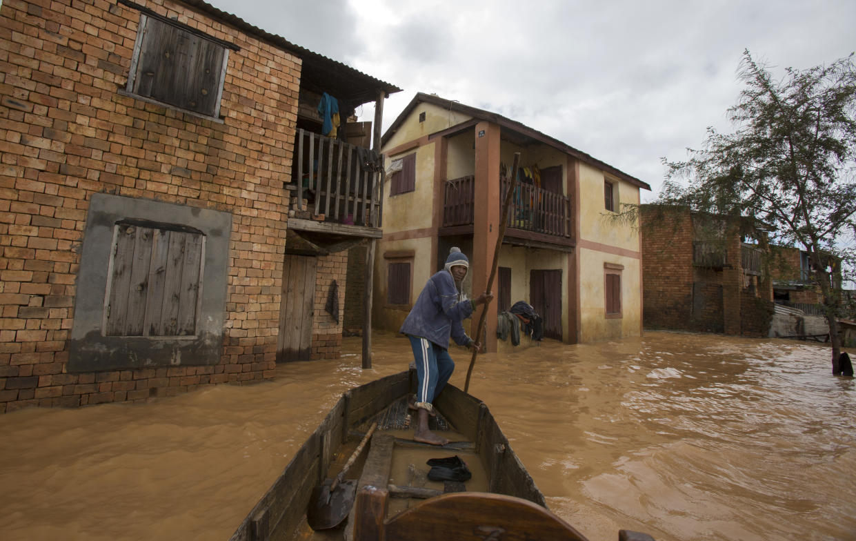 A man steers his boat that is used by residents to move around the street flooded with rain water in Antananarivo, Madagascar, Saturday, Jan. 28, 2023. A tropical storm Cheneso made landfall across north-eastern Madagascar on January 19, brought strong winds to coastal regions, while heavy rain brought significant flooding to northern parts of the country. (AP Photo/Alexander Joe)