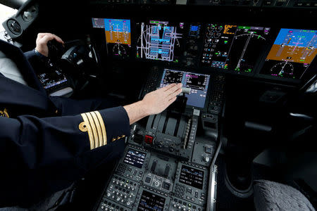 FILE PHOTO: An Air France pilot stands in the cockpit of the airline's new Boeing Inc. 787-9 Dreamliner passenger aircraft as it stands on the tarmac at Charles de Gaulle Airport in Roissy, France, December 2, 2016. REUTERS/Benoit Tessier/File Photo