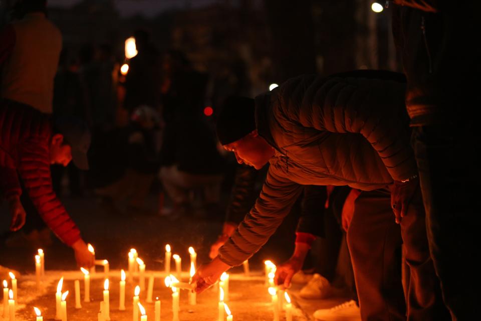 People place candles during a vigil in memory of victims of plane crash (Anadolu Agency via Getty Images)