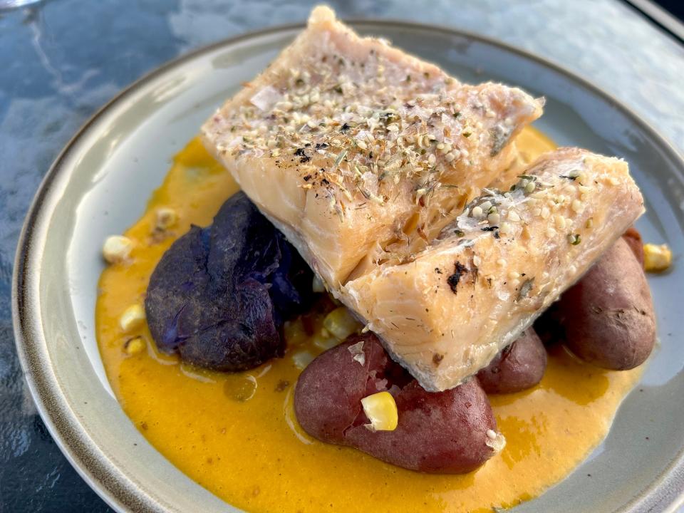 Lake Superior trout is served on a bed of rainbow potatoes over a romesco sauce with hominy at Miijim on Madeline Island.