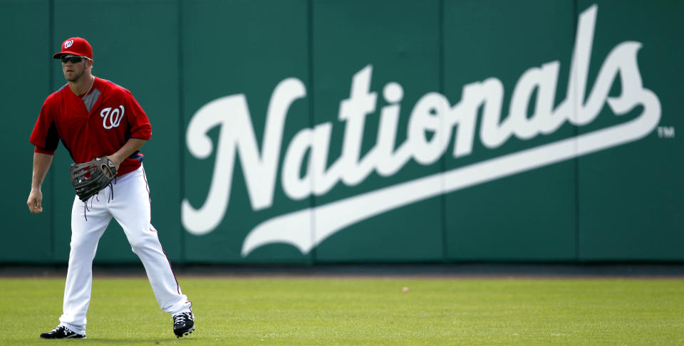 Washington Nationals prospect Bryce Harper stands in right field during spring training baseball, Thursday, March 1, 2012, in Viera, Fla. (AP Photo/Julio Cortez)