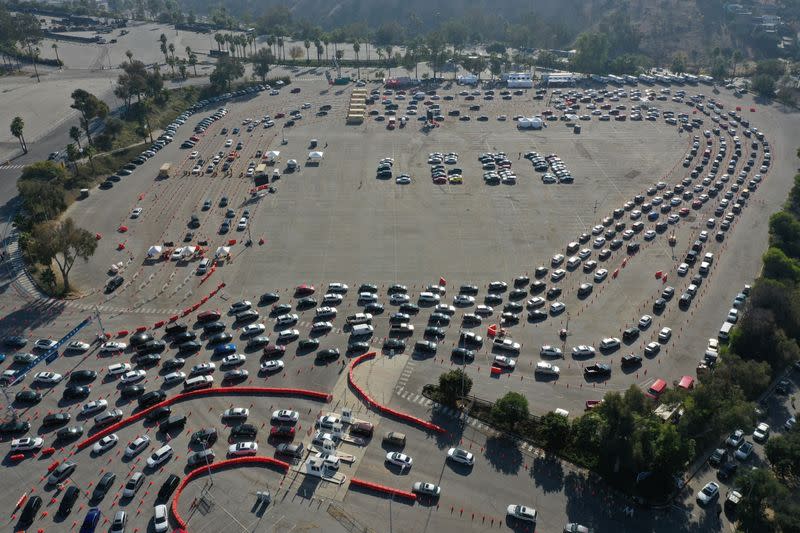 FILE PHOTO: People line up for coronavirus disease (COVID-19) tests at Dodger Stadium in Los Angeles