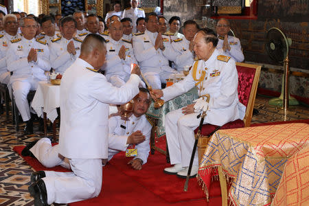 Senior Royal Thai family member Admiral M.C. Pusan Sawasdiwat (R) attends a ritual on behalf of the King Maha Vajiralongkorn to inscribe king's name and title, cast the king's horoscope, and engrave the king's official seal at the Wat Phra Kaew or the Temple of the Emerald Buddha in Bangkok, Thailand April 23, 2019. Thailand Royal Household via REUTERS