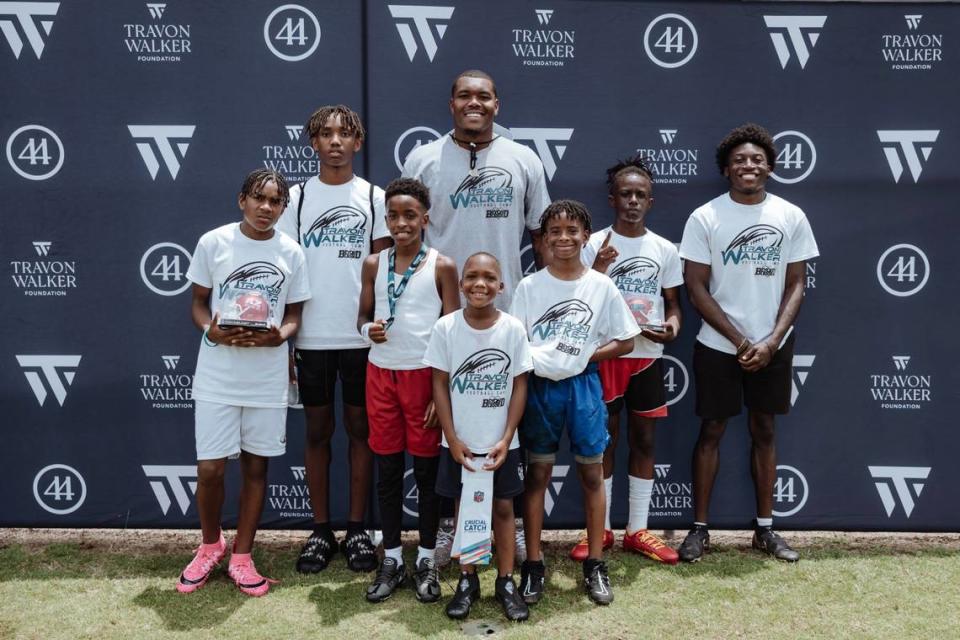 NFL linebacker Travon Walker smiles for a photo with young athletes at his inaugural youth football camp in 2023. Walker will host his 2nd annual camp on Saturday in Thomaston along with an autograph signing event in Macon Friday evening.