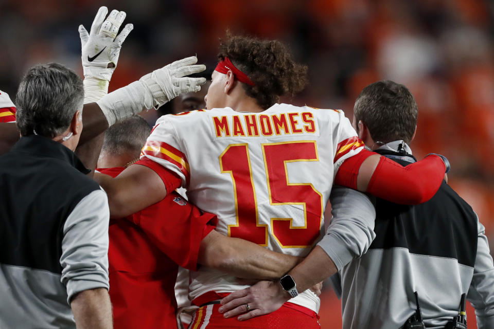 Chiefs quarterback Patrick Mahomes is helped off the field after getting injured against the Broncos on Thursday in Denver. (AP Photo/David Zalubowski)