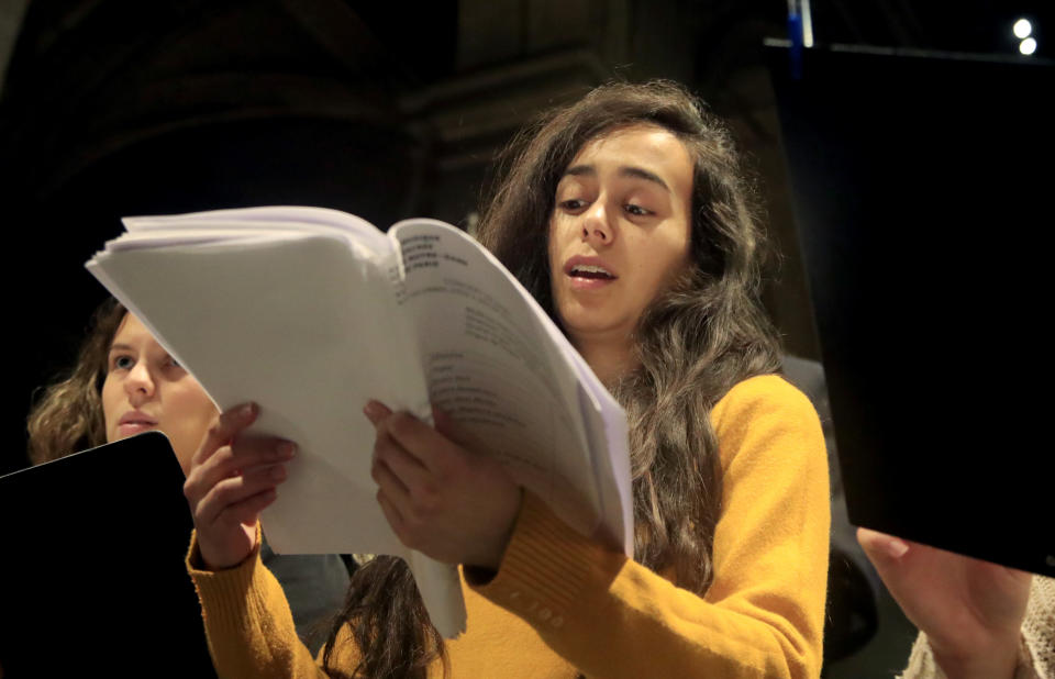 In this photo taken Monday, Dec. 16, 2019, a member of Notre Dame cathedral choir sings during a rehearsal at the Saint Sulpice church in Paris. Notre Dame Cathedral kept holding services during two world wars as a beacon of hope amid bloodshed and fear. It took a fire in peacetime to finally stop Notre Dame from celebrating Christmas Mass for the first time in more than two centuries. (AP Photo/Michel Euler)