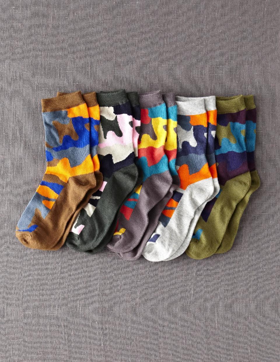 This product image released by Mini Boden shows various colored camouflage socks. The print that at one time was only a tool for military troops to go unnoticed has become a front-and-center look in fashion. It’s been adapted in luxe fur, sequin sweaters, athletic wear and casual kicks. (AP Photo/Mini Boden)