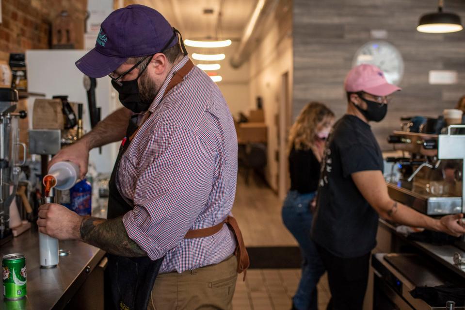 Jackson Bredehoft, Hannah Stevens and Nickolas Gavin prepare drinks at Café Rica Monday, Jan. 25, 2021, in Battle Creek.