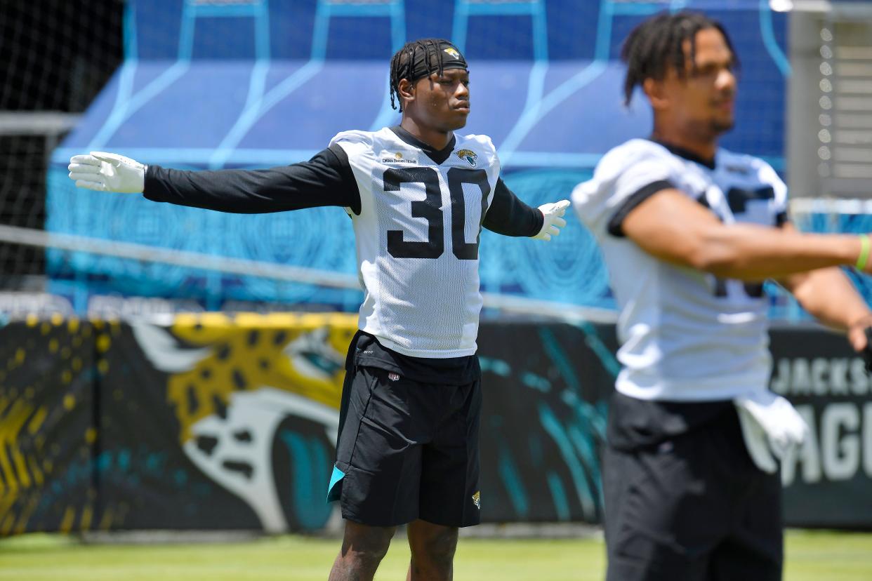 Jaguars cornerback Montaric Brown stretches with teammates during a rookie minicamp session on May 13.