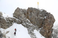 Two man climb up to the top of the highest German mountain 'Zugspitze' (2962 meters) near Garmisch-Partenkirchen, Germany, Friday, May 29, 2020. Germany's tourism is slowly restarting as the government is easing the coronavirus lockdown rules. The mountain railway will reopen tomorrow after the lockdown because of the coronavirus crisis. (AP Photo/Matthias Schrader)