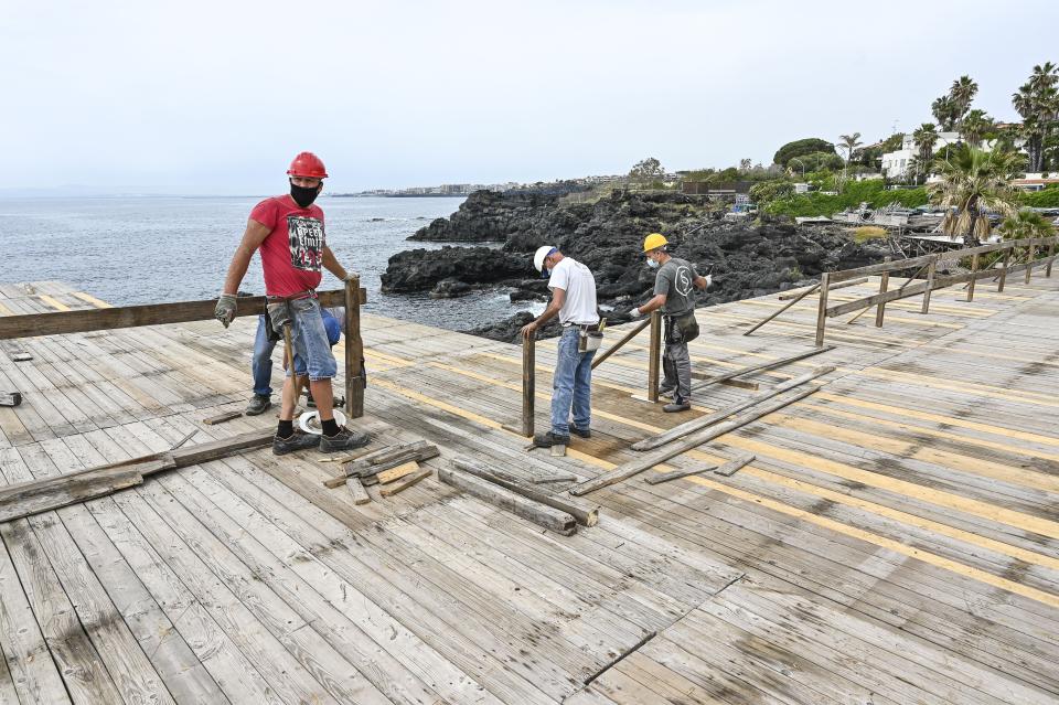 Workers during the restoration of a bathing establishment after the safety measures against Covid-19 to be followed for 'phase 2' have been established in order to ensure the resumption of activities, after the lockdown, and ensuring the protection of the health of workers and users on May 13, 2020 in Catania, Italy. Italy was the first country to impose a nationwide lockdown to stem the transmission of the Coronavirus (Covid-19), and its restaurants, theaters and many other businesses remain closed. (Photo by Fabrizio Villa/Getty Images)