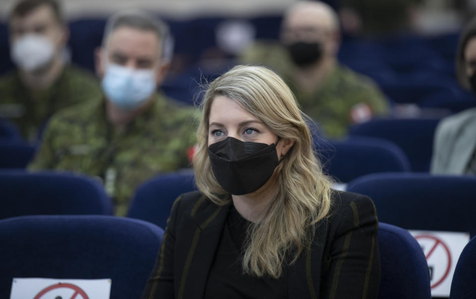 In this photo provided by Ukrainian National Guard Press Office Canada's Minister of Foreign Affairs Melanie Joly listens to a Canadian instructor's report during her visit to the National Guard base close to Kyiv, Ukraine, Tuesday, Jan. 18, 2022. (Ukrainian National Guard Press Office via AP)