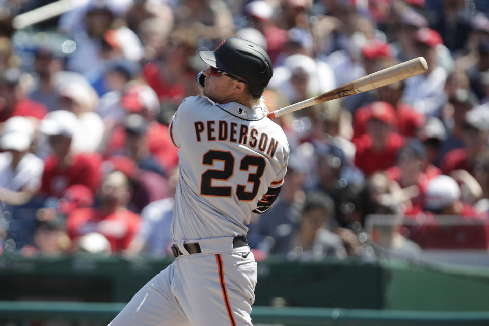 San Francisco Giants' Joc Pederson follows through on a solo home run during the first inning of a baseball game, Sunday, April 24, 2022, in Washington. (AP Photo/Luis M. Alvarez)