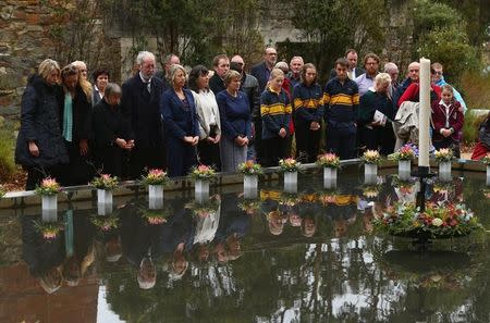 Family and community members lay 35 floral tributes in the Memorial Pool to remember the victims during the 20th anniversary commemoration service of the Port Arthur massacre, in Port Arthur, Australia April 28, 2016. AAP/Robert Cianflone/via REUTERS