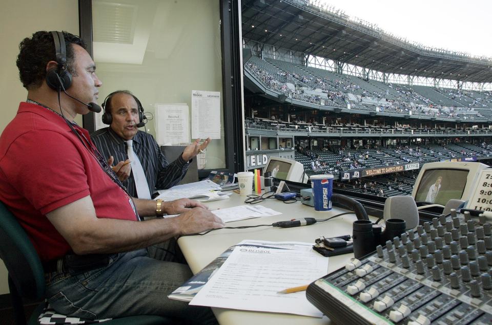 Former major league second baseman Julio Cruz, left, with broadcast partner Amaury Pi-Gonzalez, first began calling Mariners games on the radio in 2003.