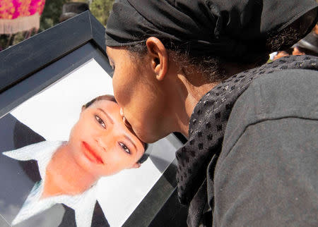 A woman kisses a portrait photo as she mourns during the burial ceremony of the Ethiopian Airline Flight ET 302 crash victims at the Holy Trinity Cathedral Orthodox church in Addis Ababa, Ethiopia, March 17, 2019. REUTERS/Maheder Haileselassie