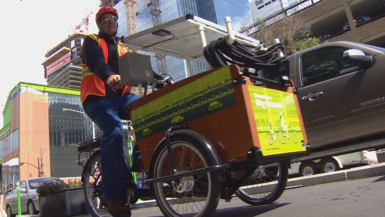 Solar-powered trikes watering plants along Edmonton's downtown bike lanes