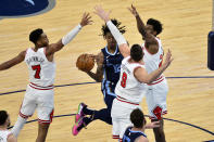 Memphis Grizzlies guard Ja Morant (12) handles the ball between Chicago Bulls forward Troy Brown Jr. (7), center Nikola Vucevic (9), and forward Thaddeus Young (21) in the second half of an NBA basketball game Monday, April 12, 2021, in Memphis, Tenn. (AP Photo/Brandon Dill)