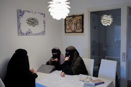 Aisha (L), 18, Sabina (C), 21, and Alaa, 21, all members of the group Kvinder I Dialog (Women In Dialogue) gather at Sabina's parents' apartment to prepare for a protest against the face veil ban in Copenhagen, Denmark, July 25, 2018. REUTERS/Andrew Kelly