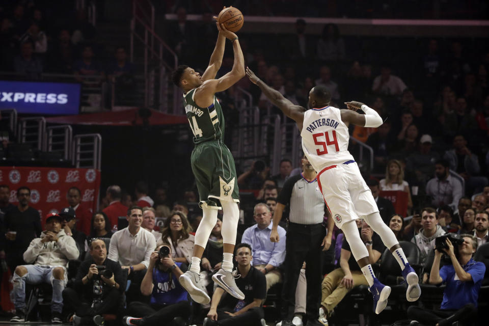 Milwaukee Bucks' Giannis Antetokounmpo, left, shoots over Los Angeles Clippers' Patrick Patterson (54) during the first half of an NBA basketball game Wednesday, Nov. 6, 2019, in Los Angeles. (AP Photo/Marcio Jose Sanchez)