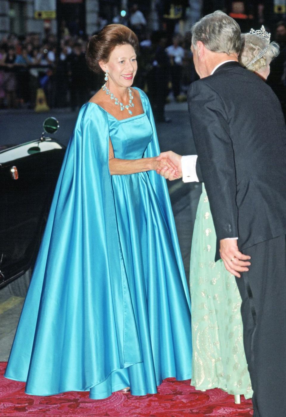 <p>Princess Margaret wears a caped blue gown to the London Palladium for the Queen Mother's 90th Birthday on July 19, 1990. </p>