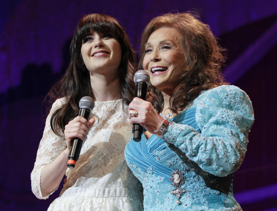 Country music star Loretta Lynn, right, and actress Zooey Deschanel sing Lynn's hit "Coal Miner's Daughter" during a performance of the Grand Ole Opry on Thursday, May 10, 2012, in Nashville, Tenn. During her appearance on the show, Lynn announced that a musical of "Coal Miner's Daughter" is in development and Deschanel will play her. (AP Photo/Mark Humphrey)