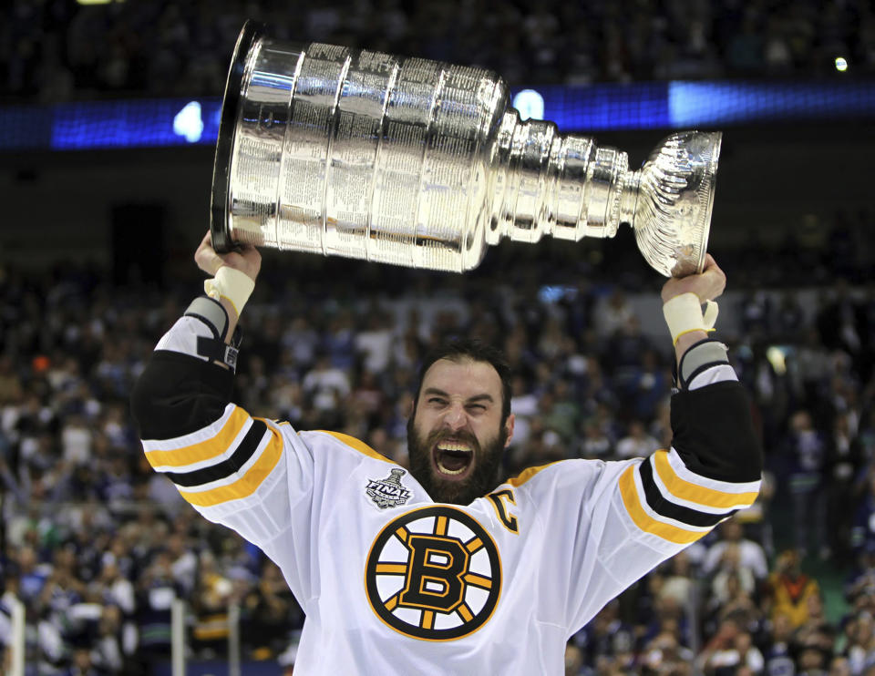 FILE - Boston Bruins' Zdeno Chara, of Slovakia, hoists the cup following the Bruins' 4-0 win over the Vancouver Canucks in Game 7 of the NHL hockey Stanley Cup Finals on Wednesday, June 15, 2011, in Vancouver, British Columbia. Chara announced his retirement Tuesday, Sept. 20, 2022, after playing 21 NHL seasons and captaining the Boston Bruins to the Stanley Cup in 2011. (AP Photo/The Canadian Press, Jonathan Hayward, File)