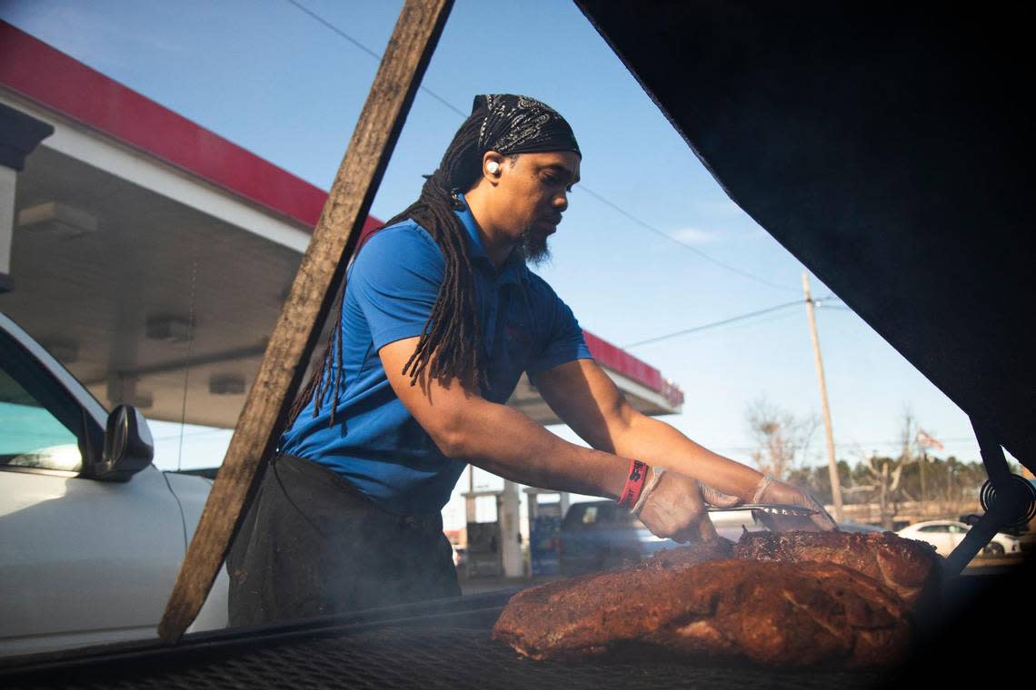 Chris Williams smokes brisket and pork at his restaurant, Roy’s Grille, located at a gas station in Lexington, South Carolina on Friday, January 7, 2022.