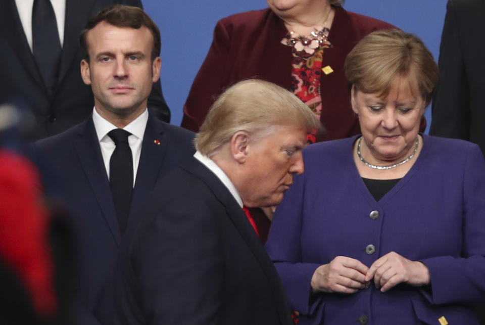 U.S. President Donald Trump, center, walks by French President Emmanuel Macron, left, and German Chancellor Angela Merkel, right, prior to a group photo of NATO leaders during a NATO leaders meeting at The Grove hotel and resort in Watford, Hertfordshire, England, Wednesday, Dec. 4, 2019. France has avoided echoing Trump’s criticism of Beijing’s handling of the coronavirus, but legislators applauded Foreign Minister Jean-Yves Le Drian last week when he condemned abuses of minority Uighurs in China’s northwest. (AP Photo/Francisco Seco, FIle)